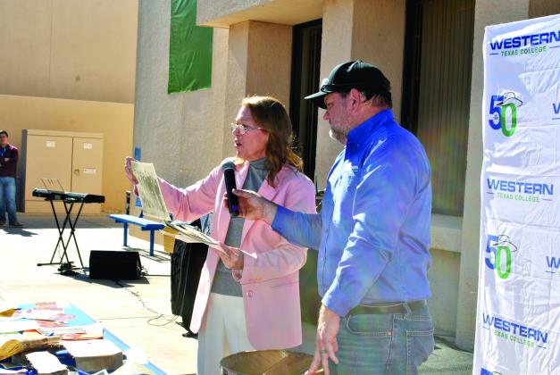 WTC President Dr. Barbara Beebe examines a photo of the college’s groundbreakng, pulled from the 1979 capsule during the college’s 50th anniversary observance, held Monday in the school’s courtyard.