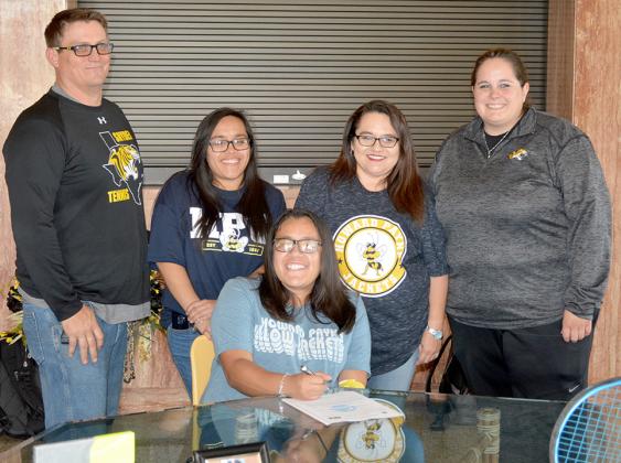Snyder High School senior Zaylie Sanchez (seated) signed a national letter of intent to play tennis at Howard Payne University. Standing are Snyder head coach Coby Hamlin, her sister Danielle Sanchez, her mother Michelle Sanchez and Snyder assistant coach Sheroke Meyer.